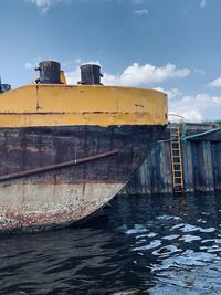 Abandoned boat on sea against sky