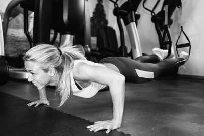 Smiling woman exercising at gym