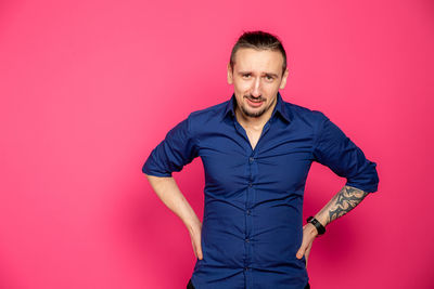 Portrait of young man against red background