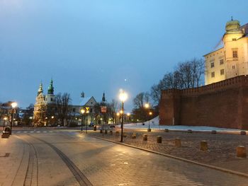 Illuminated city against sky during winter