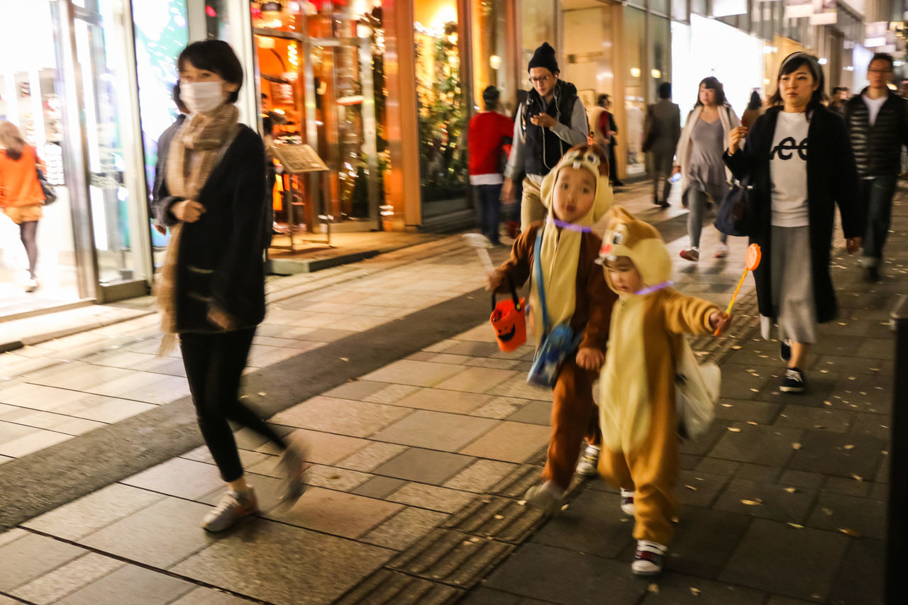 full length, women, real people, walking, men, young women, young adult, standing, lifestyles, illuminated, indoors, night, large group of people, city, adult, people, adults only