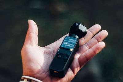 Midsection of man using mobile phone