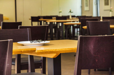 Empty chairs arranged at cafe