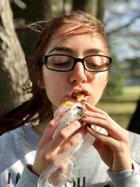 Portrait of young woman eating food