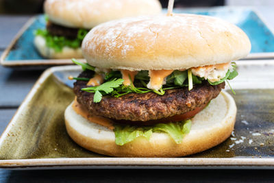 Close-up of burger in plates on table