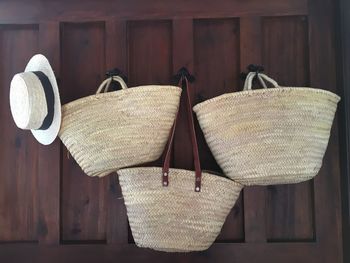 Close-up of wicker basket hanging against wall