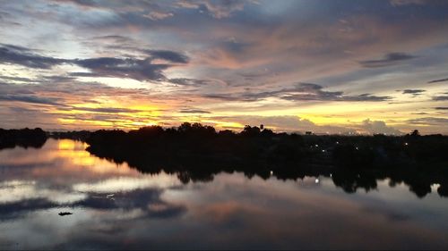 Scenic view of lake against romantic sky at sunset