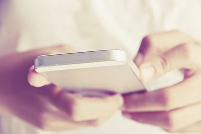 Close-up of human hand holding smart phone