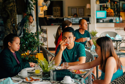 Group of people sitting on table