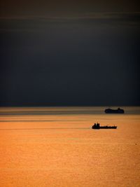 Scenic view of sea against orange sky