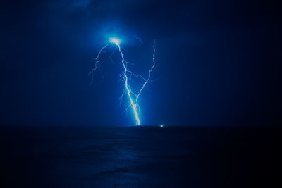 Lightning over sea at night
