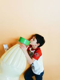 Funny boy with oversized milk bottle