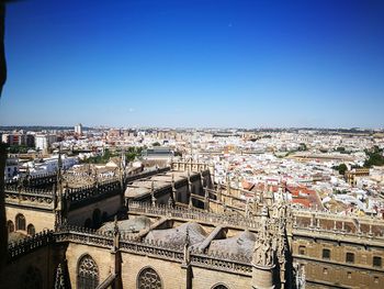 High angle view of city buildings against clear blue sky