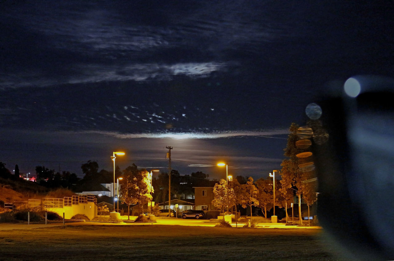 ILLUMINATED ROAD AGAINST SKY AT NIGHT