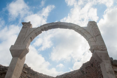 Low angle view of historical building against cloudy sky