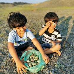 Siblings sitting outdoors