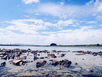 Scenic view of sea against cloudy sky