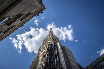 Low angle view of an old church against blue sky