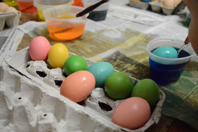 Close-up of multi colored eggs with paint on table