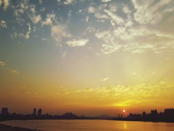 Scenic view of river at sunset