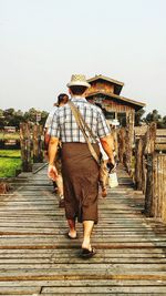 Woman walking on footbridge