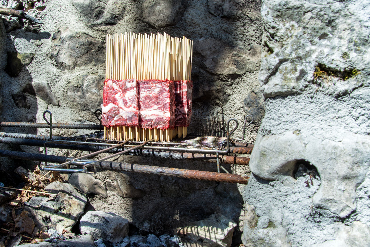 HIGH ANGLE VIEW OF BREAD ON ROCK AGAINST WALL