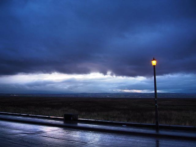 sky, cloud - sky, cloudy, street light, weather, storm cloud, overcast, tranquility, cloud, dusk, tranquil scene, nature, lighting equipment, scenics, beauty in nature, railing, landscape, dramatic sky, road, outdoors