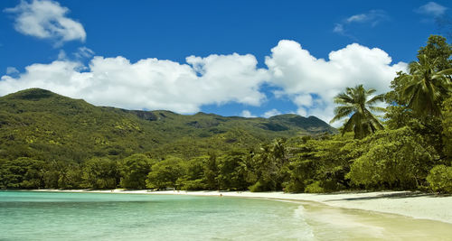 Scenic view of sea and mountains against sky