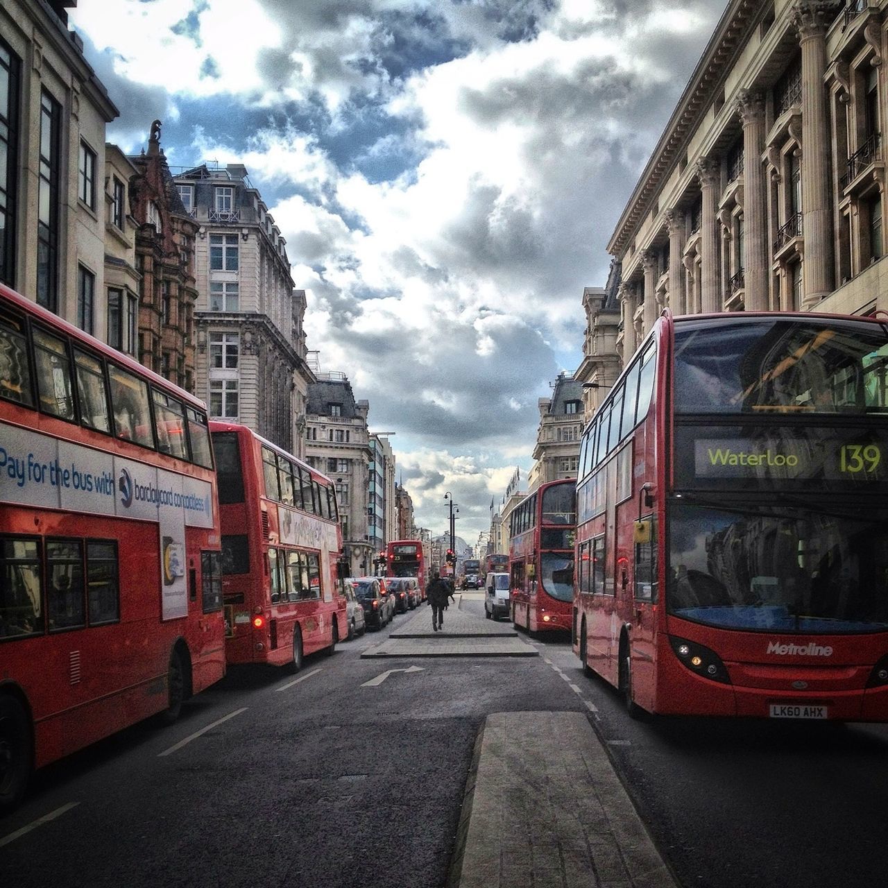 building exterior, architecture, built structure, transportation, sky, street, the way forward, diminishing perspective, car, land vehicle, mode of transport, cloud - sky, city, road, vanishing point, cloud, incidental people, residential structure, residential building, building