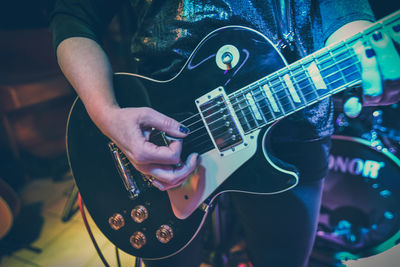 Close-up of man playing guitar