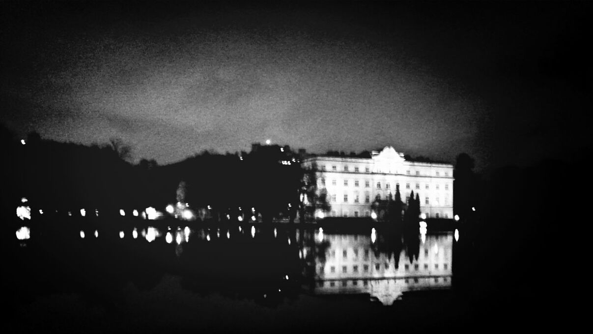 architecture, built structure, building exterior, silhouette, sky, night, illuminated, dusk, reflection, city, building, outdoors, dark, water, cloud - sky, tree, weather, low angle view, residential building, lighting equipment