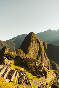 World heritage site machu picchu in peru at sunrise with sunrays on the mountain