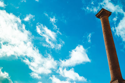 Low angle view of street light against blue sky