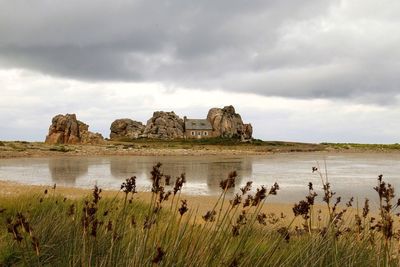 Scenic view of landscape against cloudy sky