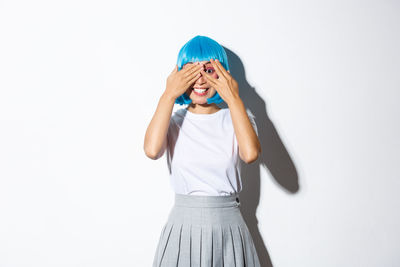 Woman standing against white background