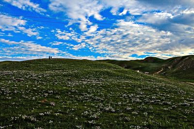 Scenic view of landscape against cloudy sky