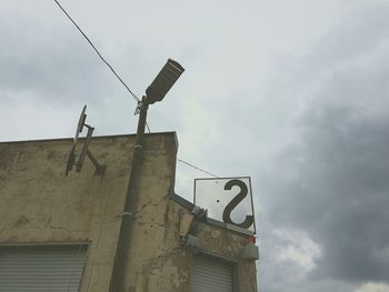 Low angle view of building against cloudy sky