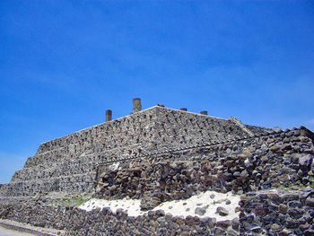 Low angle view of building against blue sky