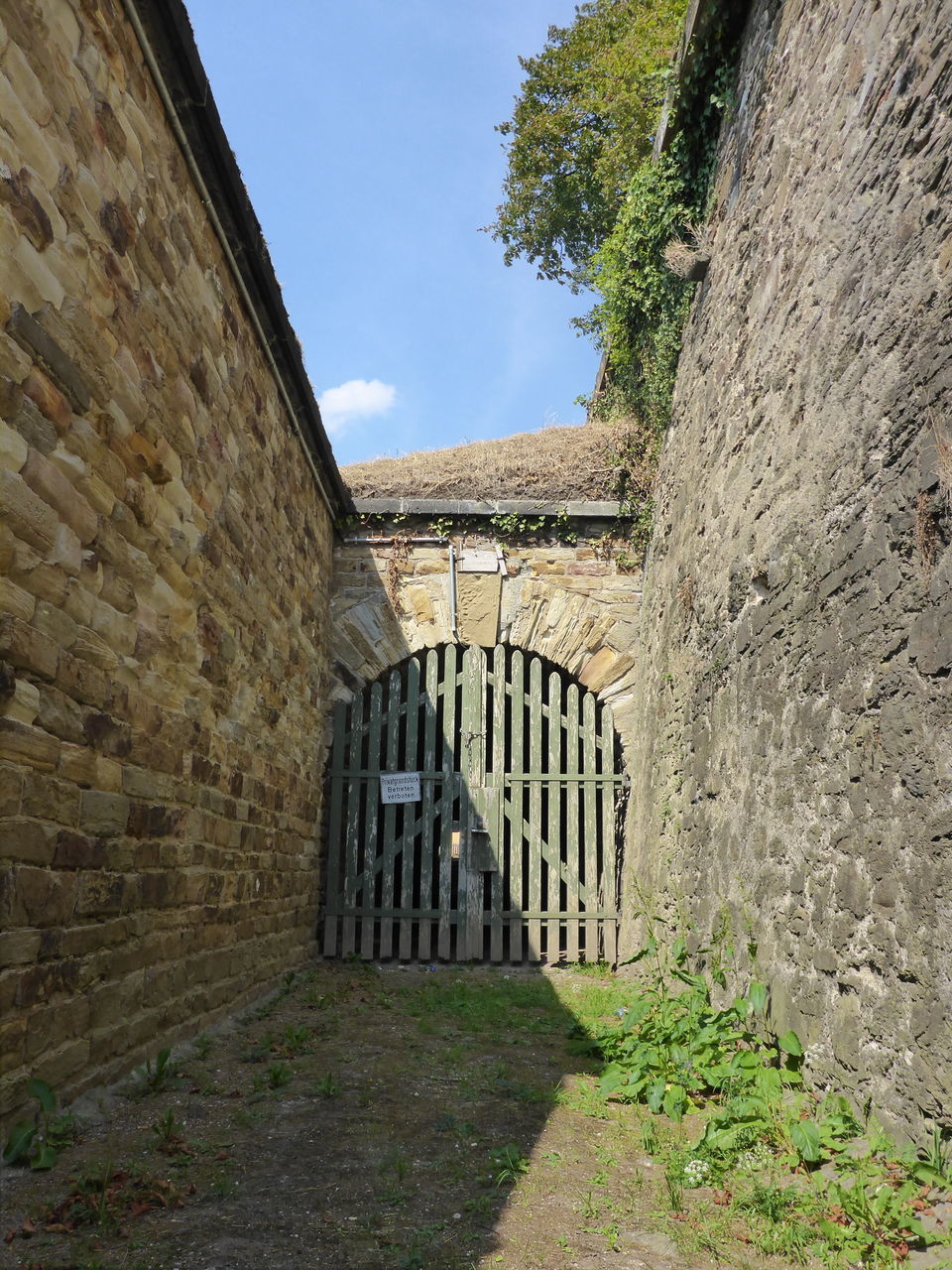 BUILT STRUCTURE BY WALL AGAINST SKY