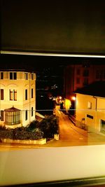 Road in city against sky at night