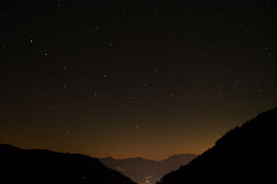 Scenic view of silhouette mountain against sky at night