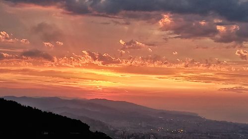 Scenic view of silhouette landscape against romantic sky at sunset