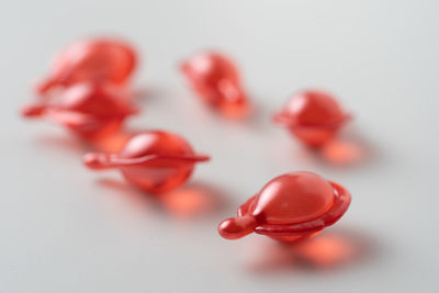 Close-up of red berries on white background