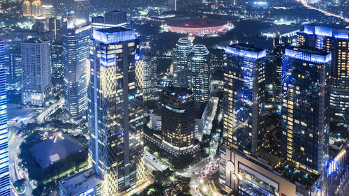 High angle view of illuminated modern buildings in city at night