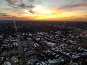 High angle view of buildings in city during sunset