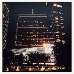 Illuminated building against sky at night