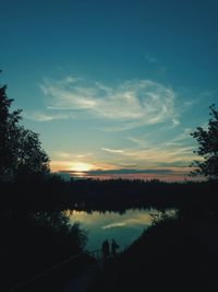 Scenic view of silhouette trees against sky at sunset