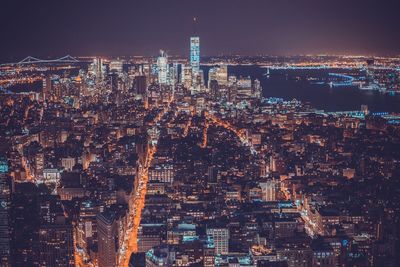 Aerial view of city lit up at night