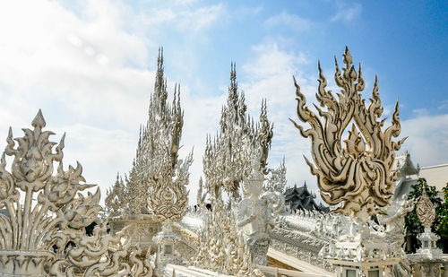 Low angle view of sculpture against building