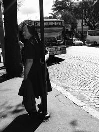 Rear view of a woman walking on road